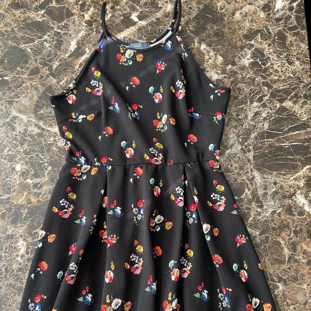 Black dress with flower patterns all over it